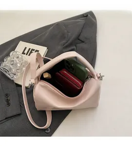 Detail showing the spacious interior of this pink glossy faux leather underarm bag