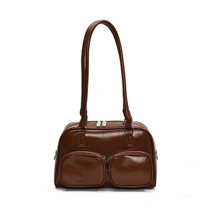 Minimalist dark brown glossy shoulder bag with dual front pockets and silver zippers
