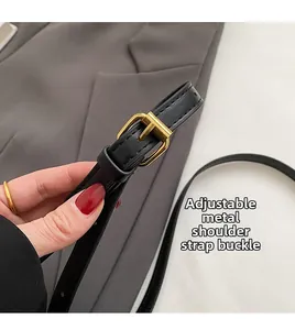 Detail of adjustable black leather strap with premium gold metal buckle for bags