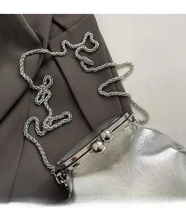 Detail of silver mini bucket bag with metallic ball clasp and delicate chain strap