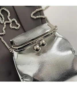Detail of silver textured leather mini kiss-lock bag with metallic chain strap