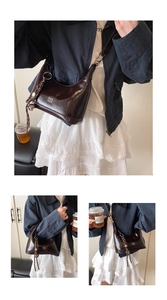 Detail of dark brown glossy leather crescent bag with silver brand lettering