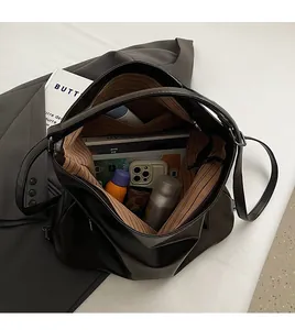 Top view of spacious black leather tote bag showing large capacity and striped lining
