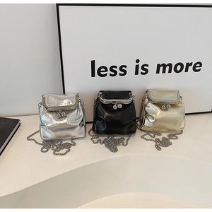 Three mini glossy leather crossbody bags in silver black and gold with chain straps