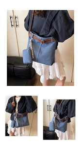 Detail of denim tote bag with brown leather belt trim and mini coin purse attachment