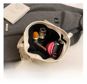 Interior view of beige tote bag with black lining showing spacious capacity for daily items