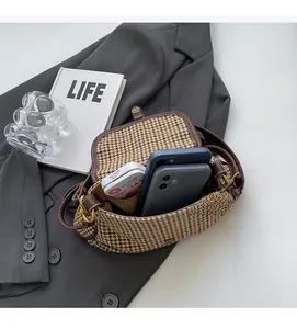 Macro shot of vintage houndstooth bag interior showing spacious capacity for two phones