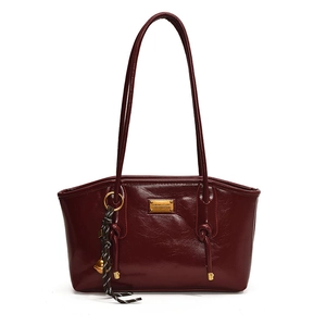Polished wine red underarm tote bag with gold metal plate and bell charm detail