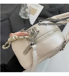 Detailed close-up of cream pillow bag with silver hardware and woven pendant decor