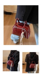 Detailed views of a vintage red leather crossbody bag with white stitch accents