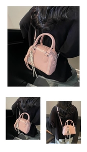 Stylish pink mini bowling handbag worn as crossbody bag, showing multiple angles and details