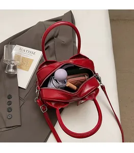Detailed interior of red glossy pillow bag showing large capacity for essentials