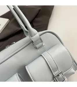 Close-up of light blue leather handbag with silver hardware and textured finish