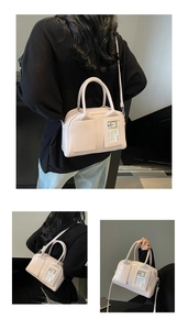 Close-up of pink vegan leather tote bag with transparent card slot and bear detail