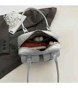 Top view of large capacity light blue shoulder bag interior with daily items and zipper pocket
