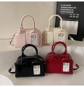 Close-up of four glossy PU leather Boston bags in pink, white, black, and red colors
