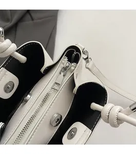 Detail of a beige bucket bag showing smooth metal zipper and secure magnetic closure