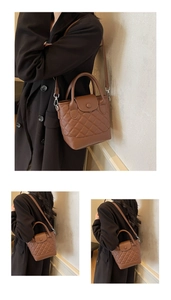 Macro detail of dark brown litchi grain leather bag with classic quilted stitching design