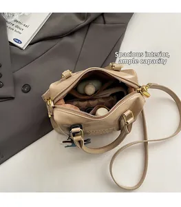 Close-up of beige leather tote interior showing spacious capacity and secure zipper pocket