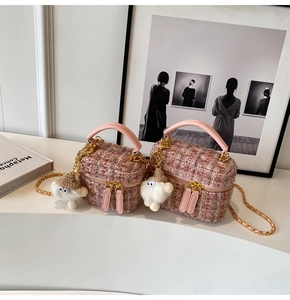 Detailed view of pink tweed box bags in large and small sizes with plush doll charms