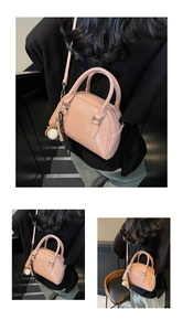 Detail view of pink leather bowling bag with baseball charm on model in various angles
