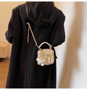 Detail of tweed chain bag with plush charm on a model's shoulder for daily commute