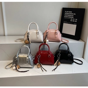 Boston style handbags in glossy patent leather with baseball charms and chain zippers