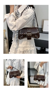 Detail of dark brown patent leather underarm bag with silver rivets and metal buckle