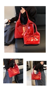 Close-up of glossy red faux leather tote and handbag with stylish ribbon bow details