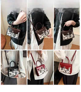 Detail view of printed crossbody bag showing versatile hand-carry and shoulder strap options