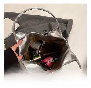 Interior view of large silver PU hobo bag with striped lining and zipper pocket