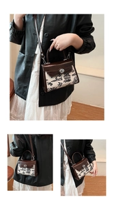 Detail of vintage floral print handbag with leather trim and silver metal twist lock