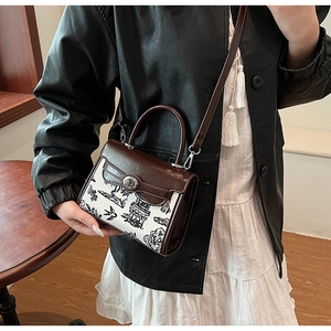 Detail of vintage ink wash landscape print crossbody bag with brown leather top handle