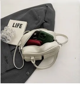 Interior view showing the large capacity for a phone, wallet, and lipstick in this bag