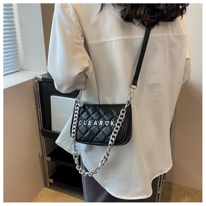 Close-up of quilted black PU leather bag with silver chain and CLEAR logo detail