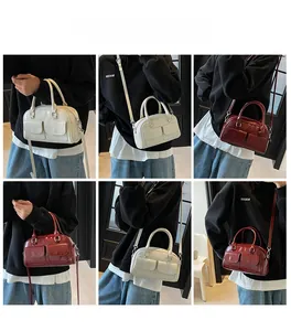 Boston bag model showcase in cream and wine red with adjustable shoulder straps