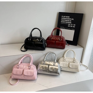 Detailed group shot of five oil wax leather Boston bags in various colors on a display stand