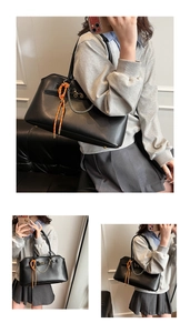 Macro detail of black leather tote bag featuring silver chain and woven rope ornament