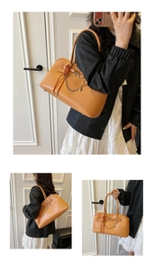 Detail of caramel faux leather tote bag featuring a metal chain and woven strap accessory
