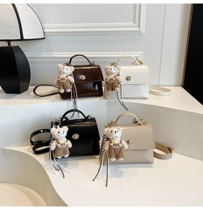 Minimalist crossbody bags in four colors featuring golden locks and plush bear pendants