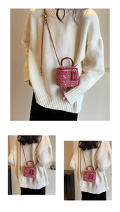 Pink tweed chain crossbody bag with dual zipper closure and metal strap adjustment ball