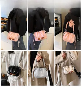 Detail of trendy cloud bucket bags in multiple colors with woven rope handles