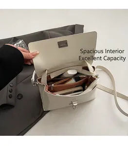Interior view of white crossbody bag with multiple compartments and zipper pocket