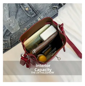 Internal capacity of the red leather bucket bag showing large storage space and pockets