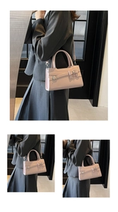 Close-up detail of pink rectangular leather handbag with bow decoration and metal buckle