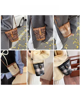 Detail view of retro plaid bucket bags showing adjustable straps and metal buckles