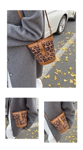 Leopard print bucket bag styled with a gray wool coat and white pants in a street setting