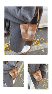 Detail of retro plaid bucket bag with brown leather trim and golden twist lock