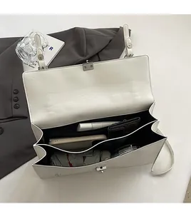 Detail view of white lychee leather handbag interior showing double layer storage space