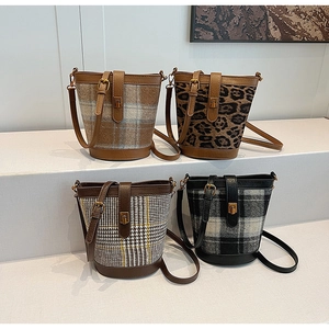 Detail of wool bucket bags featuring leopard print and various classic plaid patterns